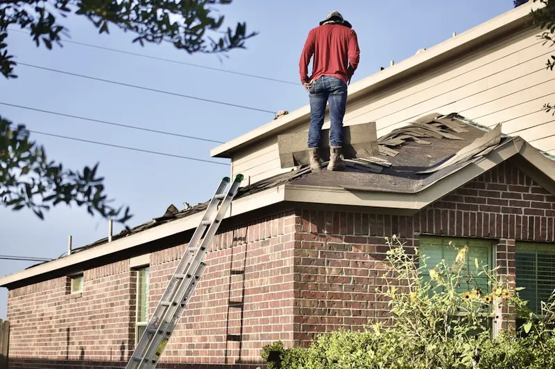 Professional roofer working on a residential roof in Forest Falls